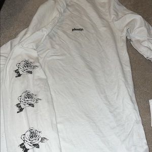 White long sleeve with roses on sleeve